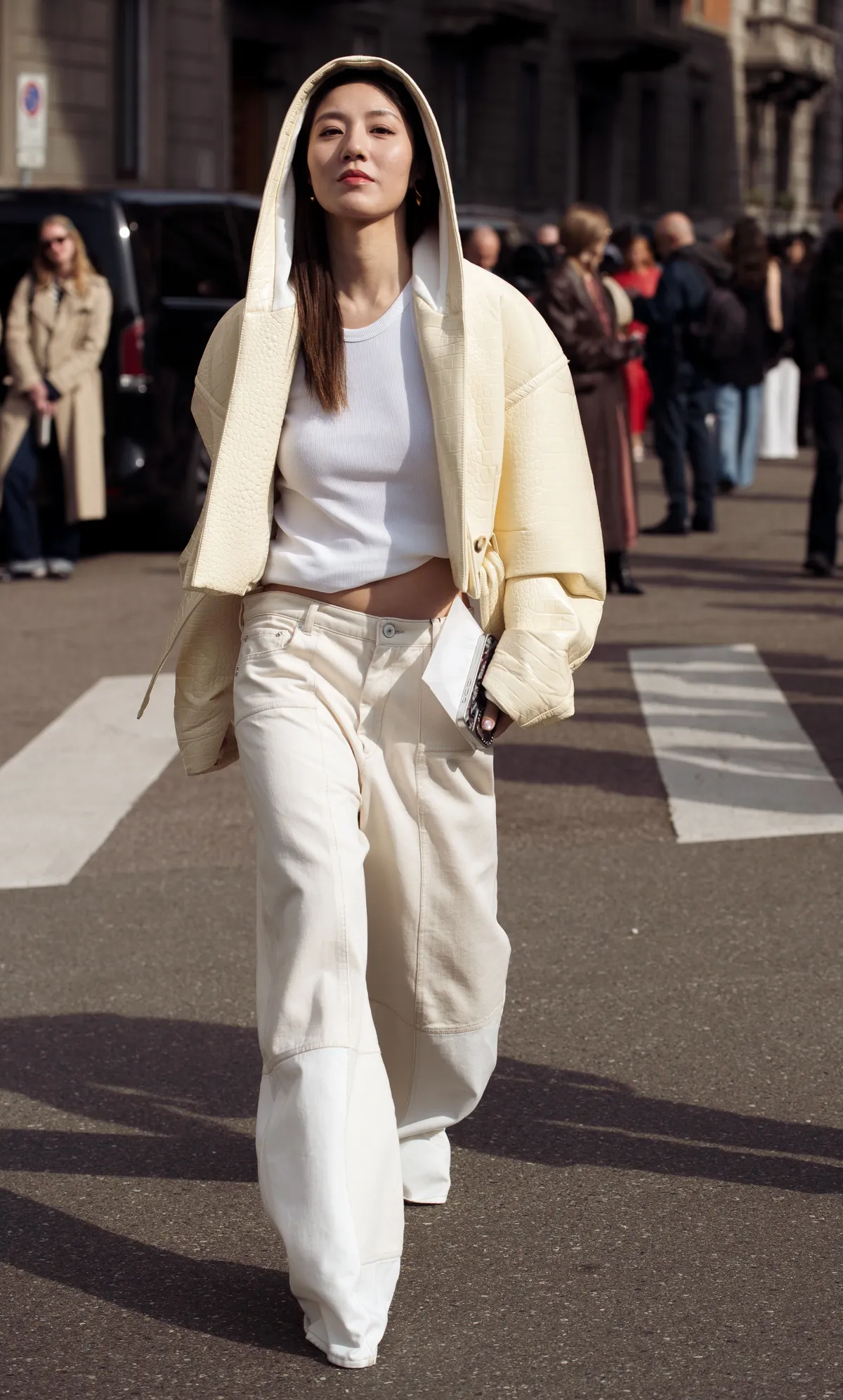 MILAN, ITALY - FEBRUARY 28: A guest wears white jeans, white top and creme pale yellow leather jacket with a hood outside the Sportmax fashion show during the Milan Fashion Week Womenswear Fall/Winter 2025/2026 on February 28, 2025 in Milan, Italy. (Photo by Raimonda Kulikauskiene/Getty Images)