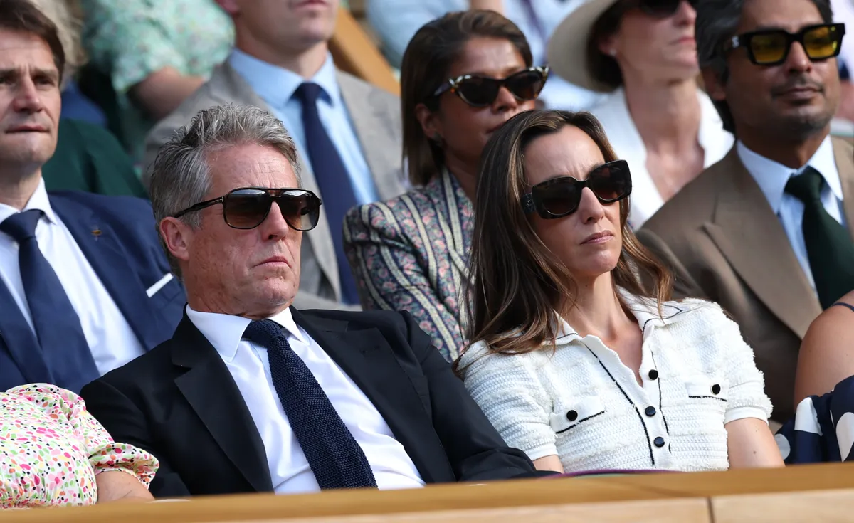 LONDON, ENGLAND - JULY 09: Actor, Hugh Grant and Anna Elisabet Eberstein watch in the Royal Box during the Gentlemen's Singles quarter-final match between Flavio Cobolli of Italy and Novak Djokovic of Serbia on day ten of The Championships Wimbledon 2025 at All England Lawn Tennis and Croquet Club on July 09, 2025 in London, England. (Photo by Clive Brunskill/Getty Images)
