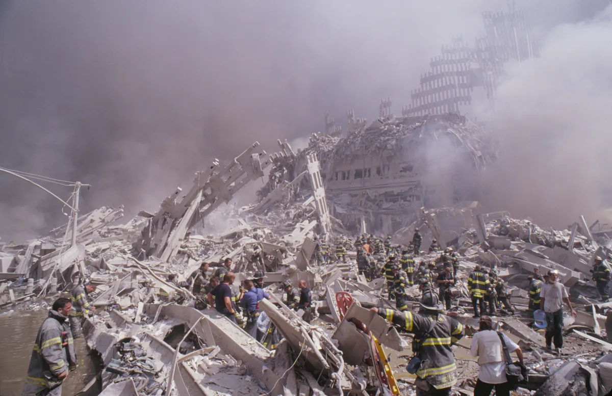 September 11, 2001, New York, New York, USA: Dust and smoke fill the air as New York Fire Department firemen climb the remains of the Marriott Hotel and the remains of the second WTC tower in the afternoon, just hours after the 9/11 attack on the World Trade Center. (Credit Image: © Randy Taylor/ZUMA Press Wire Service)