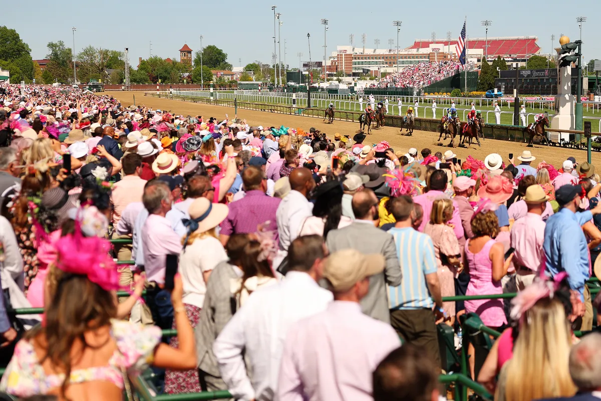 LOUISVILLE, KENTUCKY - MAY 05: Spectators look on as horses finish a race ahead of the 149th running of the Kentucky Derby at Churchill Downs on May 05, 2023 in Louisville, Kentucky. (Photo by Michael Reaves/Getty Images)